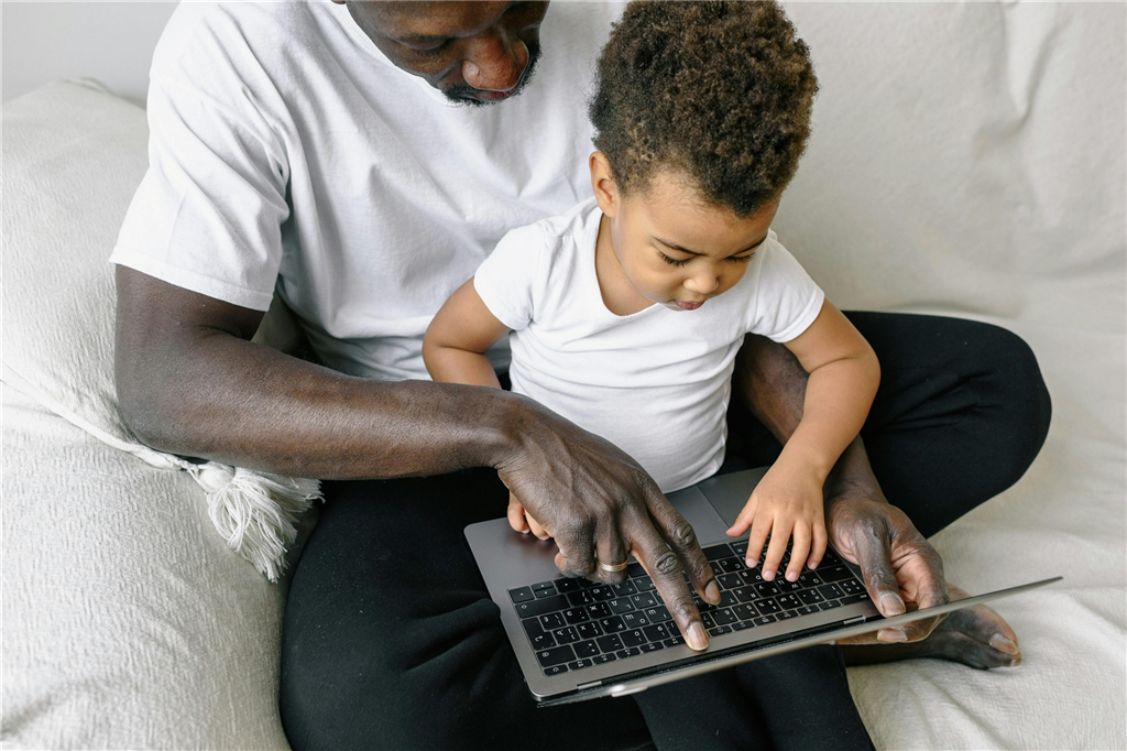 Dad and child on laptop