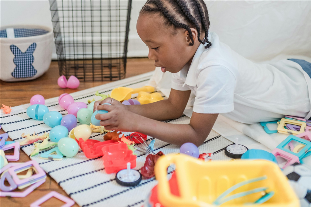Child laying with toys
