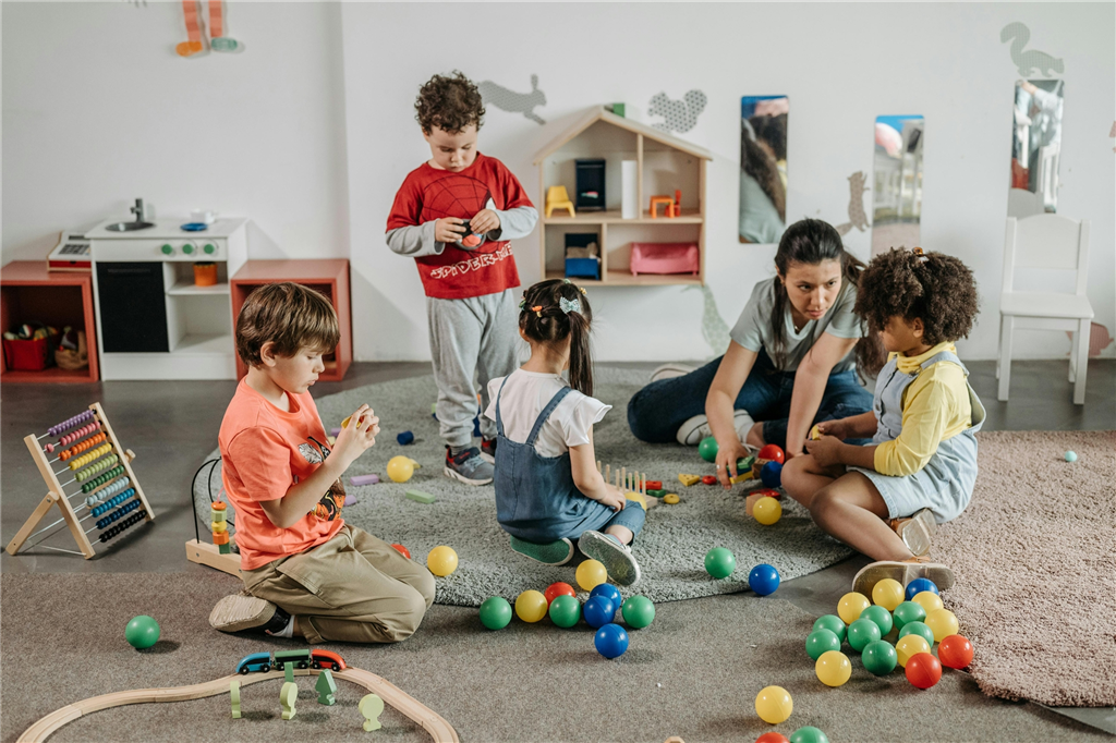Teacher sitting with children
