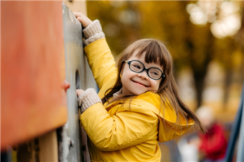 young child climbing on a climbing wall